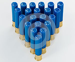 Pyramid of blue 410 gauge shotgun shells in a pattern