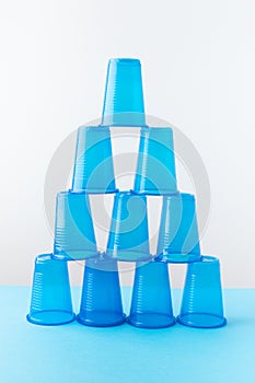 Pyramid of blue plastic cups. Set for party.