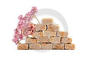 Pyramid of brown cane sugar with flowers