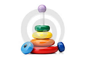 A pyramid build from rings, isolated on a white background. Colorful wooden toys for babies. Learning child pyramid toy.