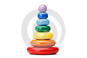 A pyramid build from rings, isolated on a white background. Colorful wooden toys for babies. Learning child pyramid toy.