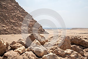 Pyramid Cheops in Giza and stones on foreground