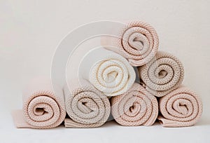 A pyramid of colorful cotton plaids rests on the table.