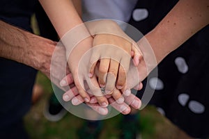 A pyramid of family hands - parents and two children