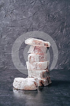 Pyramid of freshly frozen Macrourus fish. Gray background