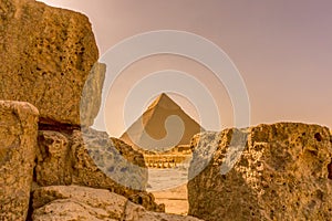 Pyramid in Giza framed between limestone blocks