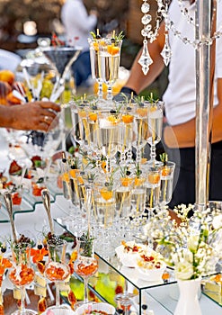 Pyramid of glasses of champagne. Wedding table decoration. Celebration and party. Catering concept.