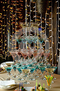 Pyramid of glasses with cocktails at furshet