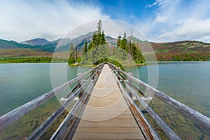 The Pyramid island in spring with color changing background in Alberta, Canada