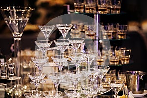 Pyramid of martinis glasses on a cocktail reception on wedding party