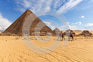 The Pyramid of Menkaure with three pyramids of the queens and bedouins near them