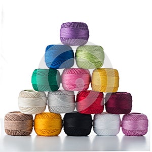 pyramid of multicolored balls of thread isolated on white