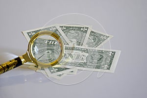 Pyramid of one-dollar banknote inside a magnifying glass