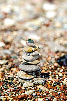 Pyramid of pebbles built on a pebble beach.