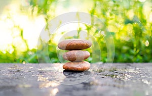 Pyramid pebbles on wood outdoor nature blur bokeh background. stack old zen stone for stability, equilibrium, calm, meditation,