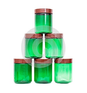 A pyramid of plastic polypropylene green jars on a white background, isolate