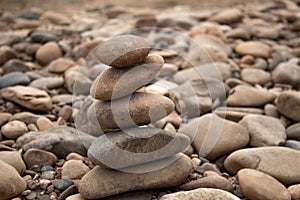 Pyramid of rounded stones in nature