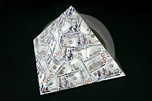 a pyramid scheme isolated on black background. concept of financial fraud. The dollar as a global financial pyramid