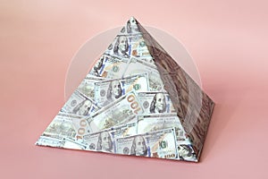 a pyramid scheme isolated on pink background. The concept of exchange in financial markets is the collapse of the financial system