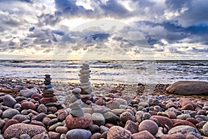 Pyramid of sea stones on pebbles of the sea shore