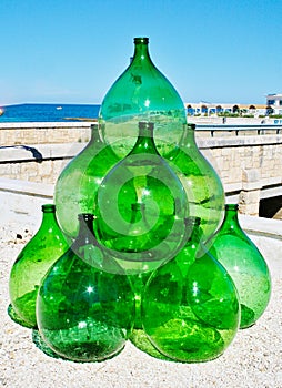 Pyramid set of vintage green glass large bottles demijohns for wine