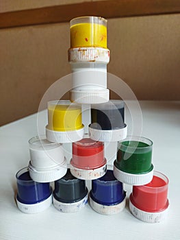 a pyramid of small cans of paint