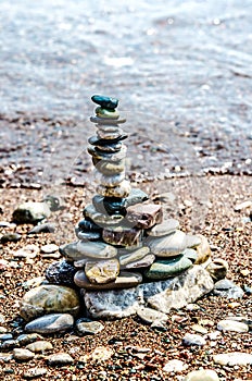 Pyramid of small stones on the coast.