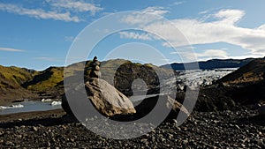 Pyramid of stones against the background of a glacier.