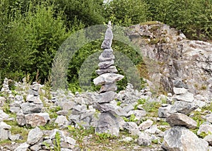 Pyramid of stones on the background of nature. The stones balance form a pyramid shape. Demonstration for Zen meditation