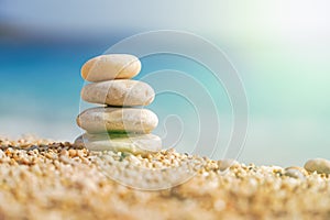 Pyramid Stones Balance at sea background with sunlight