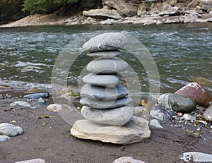 Pyramid of stones on the banks of the river.