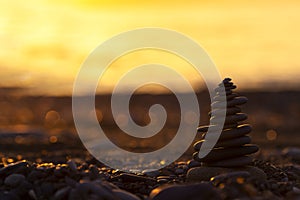 Pyramid of Stones on the Beach at Sunset, Beautiful Seascape, Seaside vacation concept, Panoramic Background, Balance