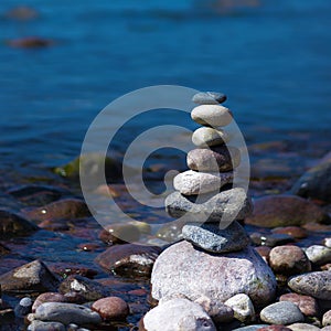 Pyramid of stones in the nice calm evening.On the sea shore a pyramid of stones. Dream on the beach