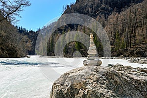 Pyramid of stones on large boulder