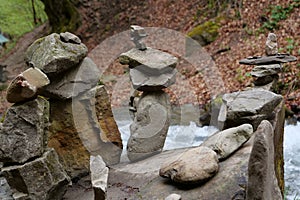 Pyramid of stones near beautiful small river