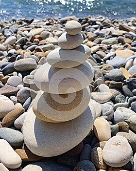 pyramid of stones on the seashore. pyramid with stones different sizes. photo