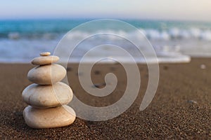 Pyramid of stones on the seashore. Zen concept. Concept of harmony, stability, life balance, relaxation and meditation. Blurred