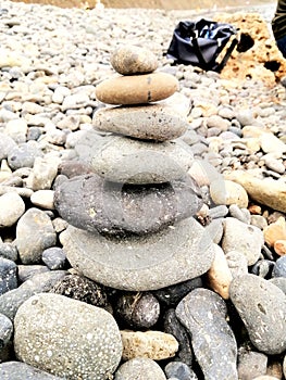 A pyramid of stones stacked on the seashore