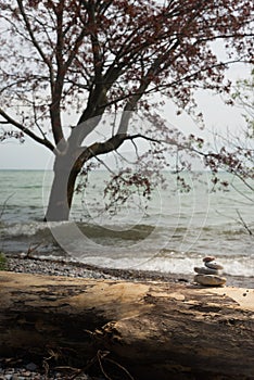 The pyramid of the stones with tree in the water as a background