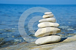 Pyramid of stones zen balance in sea shore