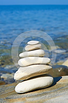 Pyramid of stones zen balance in sea shore