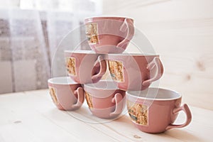 Pyramid of tea mugs side view