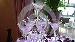 Pyramid tower of glasses with champagne. Sparkling alcohol wine at the party, celebration, wedding, birthday or