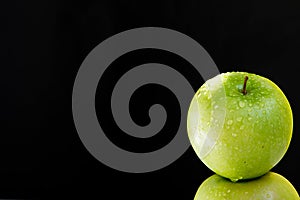 Pyramid of two fresh juicy wet apples on black background