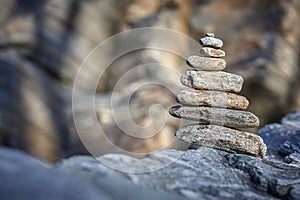 Pyramid of various stones on a background of rock