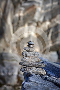 Pyramid of various stones on a background of rock