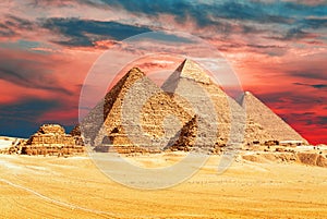The Pyramids of Egypt in the sands of Giza desert, sunset view, Egypt