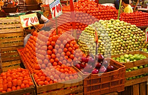 Pyramids of fresh tomatoes, indoor market,