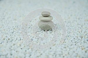 Pyramids of gray and white zen pebble meditation stones on white background. Concept of harmony