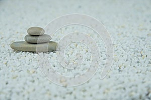 Pyramids of gray and white zen pebble meditation stones on white background. Concept of harmony